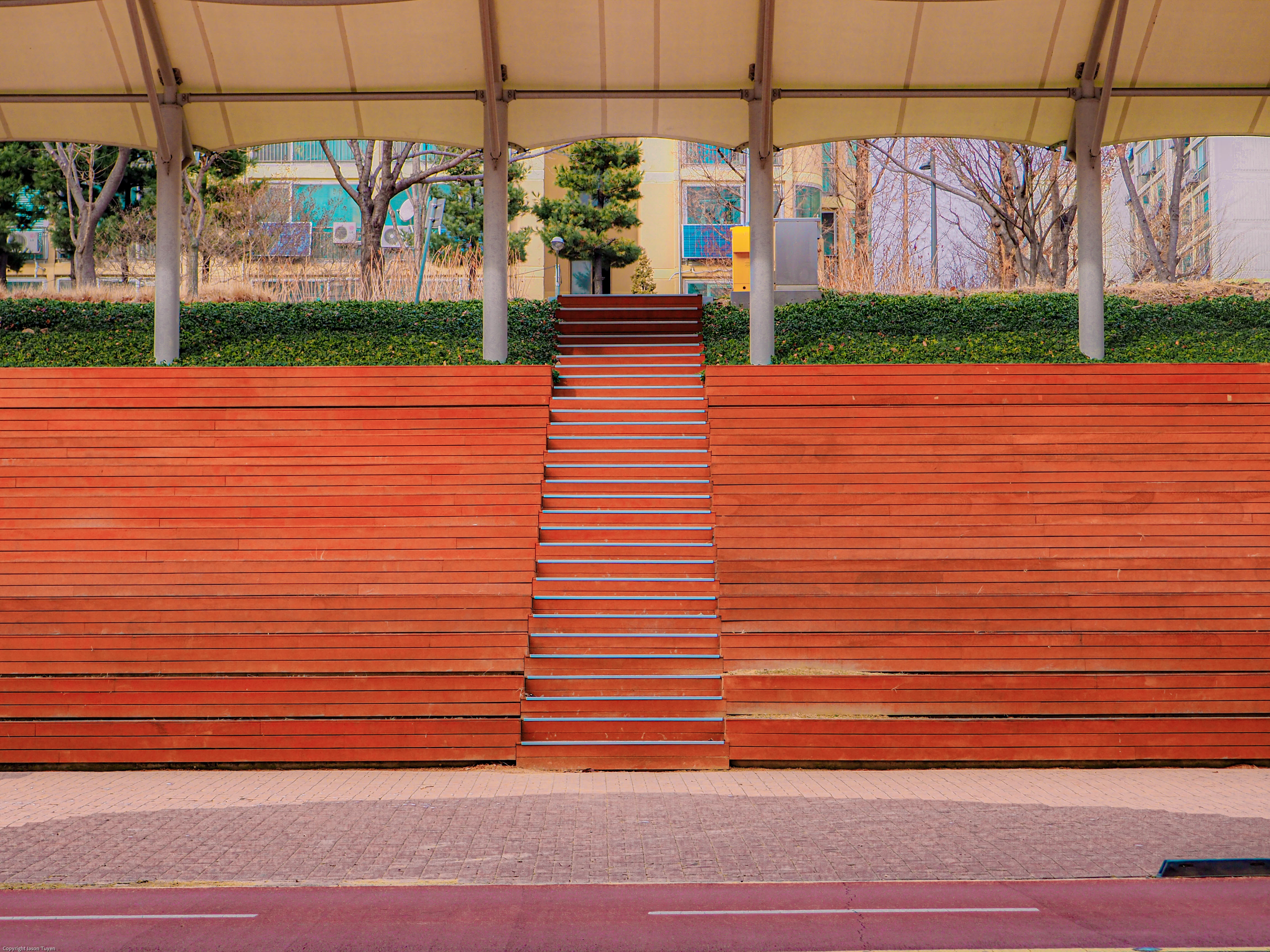 Red outdoor stadium seats located in a Seoul park.