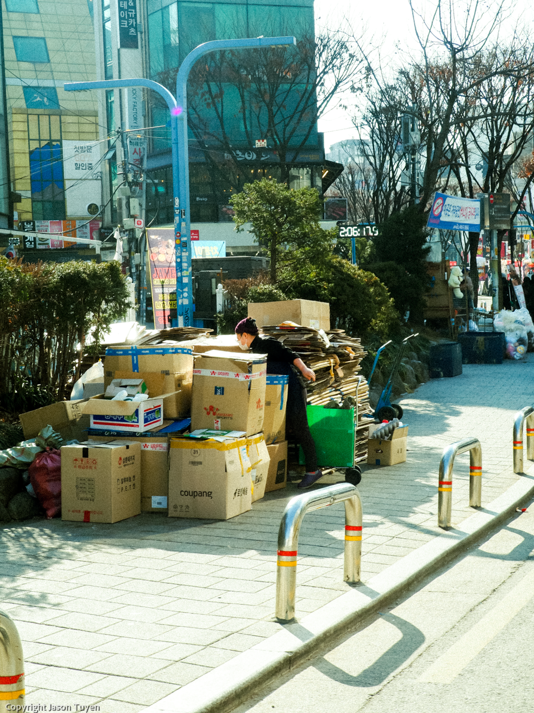 An employee recycle boxes on the streets of Hongdae.