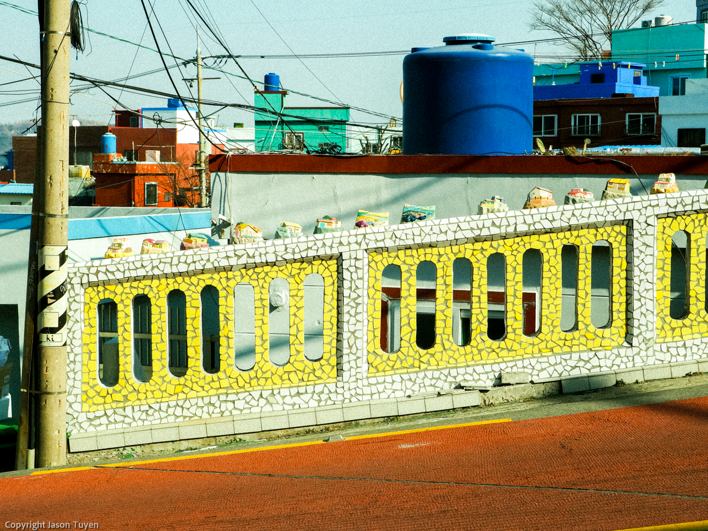 Tiny toy houses sit atop a highway divider near Busan's Gamcheon Village